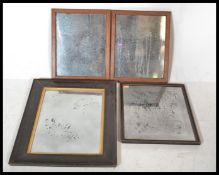 A group of four vintage early 20th century mirrors having wooden frames with inset foxed mirror