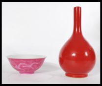 An early 20th century Chinese monochrome baluster vase along with a Chinese dragon bowl in a