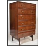 A retro mid century lacquered chest of drawers and dressing table having decorative handles and