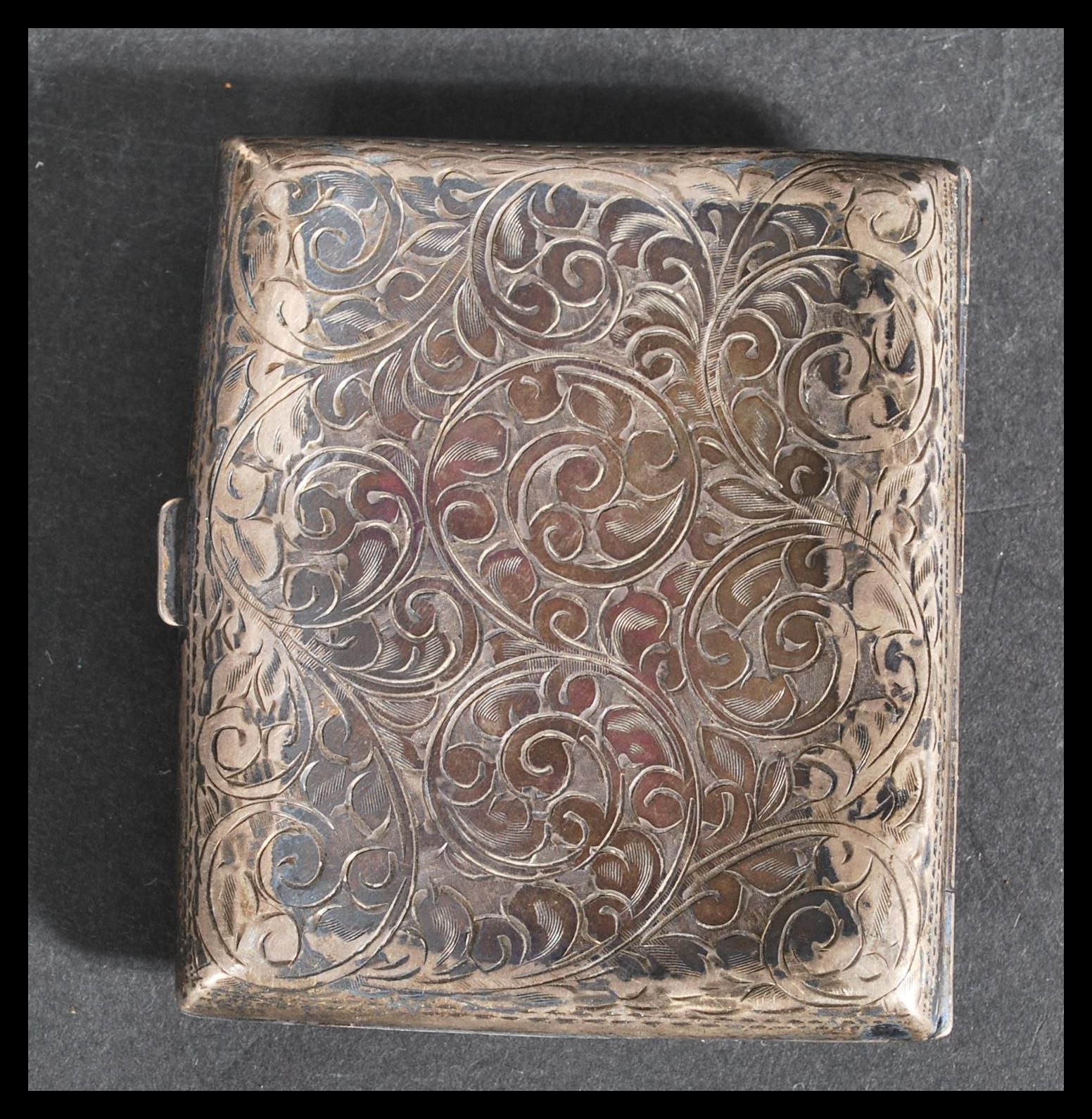 A silver hallmarked hinged chase decorated cigarette case, assay marks for Birmingham, dating to - Image 2 of 5