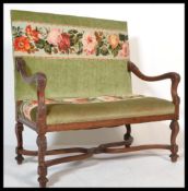 An 18th / 19th century walnut hall settle bench being upholstered in a green velour and tapestry