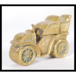 A brass cased vesta in the form of a vintage car with no. 32 to side.