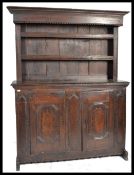 An 18th century country oak large French dresser. The base of solid heavy oak with twin doors having