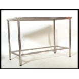 A 20th century Industrial medical theatre table of stainless steel construction. The rectangular top