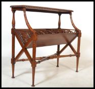 A Regency style carved mahogany two tier book trough with open fretwork and raised on turned