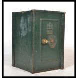 An early 20th century cast iron safe with central door and in original paintwork, The with handle in