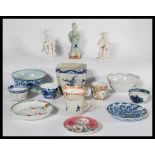 A collection of Chinese ceramics dating from the 19th century to include tea bowls , figures , bowls