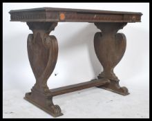 A Victorian oak writing table desk being raised on