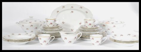 A vintage bone china tea service in the manner of Old Country Roses consisting of tureens , plates