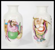 A pair of 19th century Chinese miniature vases depicting two Buddhas one in robe and one holding a