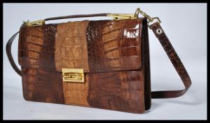 A 20th century ladies handbag / clutch bag in crocodile skin with appointed sectional interior