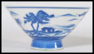 An 18th century Chinese blue and white porcelain bowl of conical form raised on a circular foot.