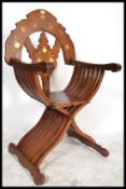 A 20th century hardwood brass inlaid Savonarola throne chair having shaped base with carved back