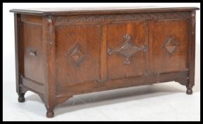 A good early 20th century Jacobean revival coffer chest having a flared hinged top set over a wide
