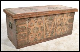 A vintage 20th Century hardwood and brass mounted studded dome top trunk, hinged lid with carry