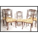 A set of four early 20th Century Edwardian mahogany dining chairs, over stuffed seat pads with