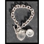 A sterling silver 925 heavy rolo link bracelet chain with large heart bentant and T bar and hood