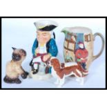 A collection of ceramics to include a Beswick Spaniel, Goebels dog, Toby Jug etc please refer to