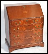 An Edwardian style mahogany inlaid bureau desk being raised on bracket feet with bank of drawers