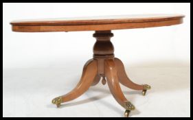 A Victorian mahogany oval inlaid coffee table raised on sabre reeded legs with castors to the