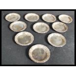 A matching set of ten continental silver peanut dishes / pin trays of scalloped form each being