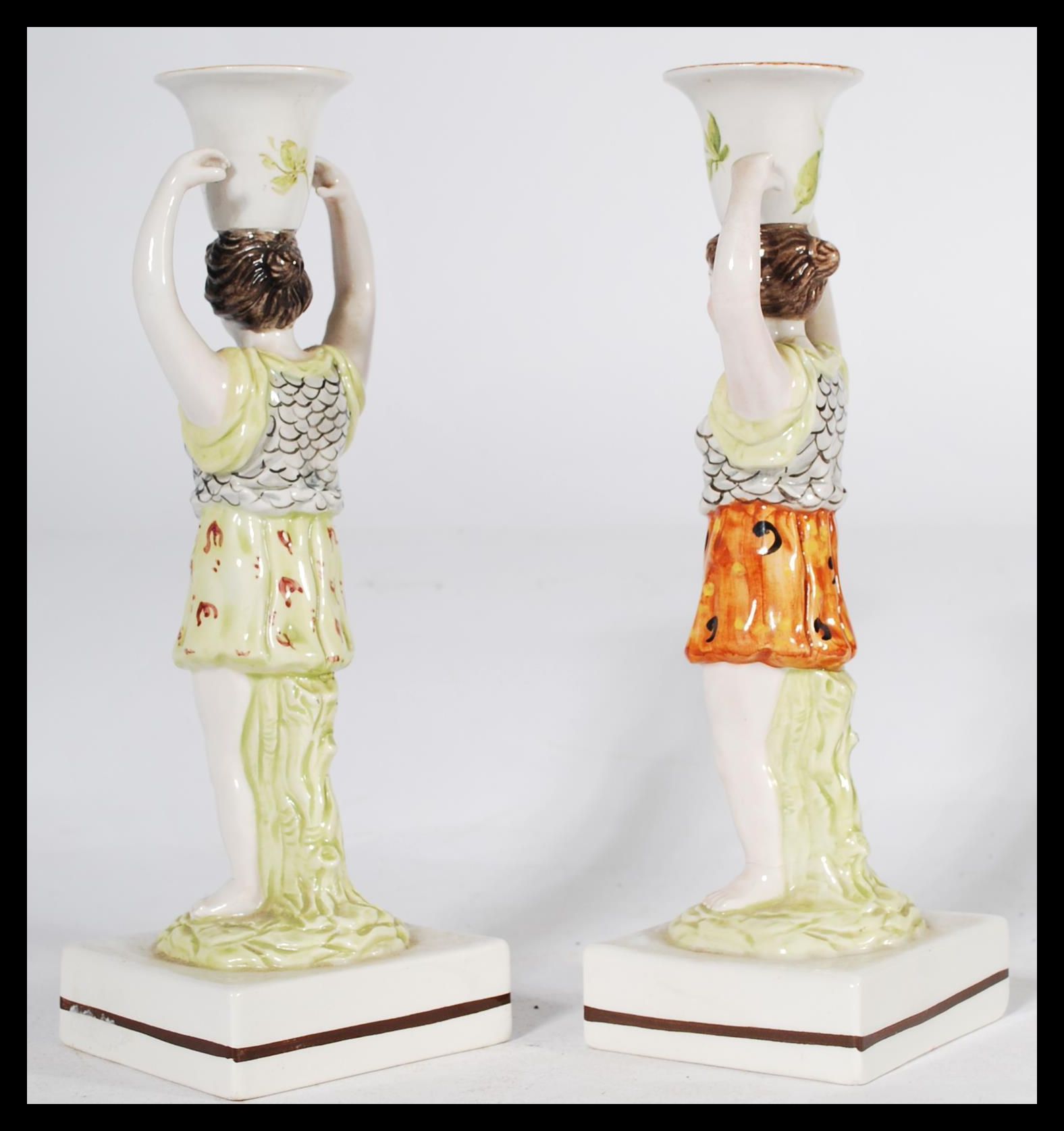 A pair of 19th century Staffordshire figural candlestick holders raised on square bases in the - Image 2 of 6