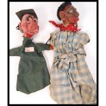 A pair of 1920's antique vintage paper mache handmade hand puppets, one in the form of a school