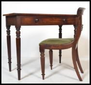 A Victorian mahogany writing table desk raised on turned and tapering legs with fitted frieze