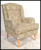 A 20th Century Wesley - Barrell wing back armchair upholstered in a William Morris inspired print