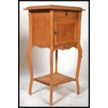 A 20th century French walnut bedside pot cupboard, single drawer over cupboard, shaped top with