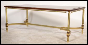 A 20th century campaign style brass, mahogany and glass rectangular coffee table. The inset glass