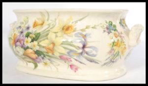 An Ironstone china large footbath with twin handles and a chintz pattern being stamped to the