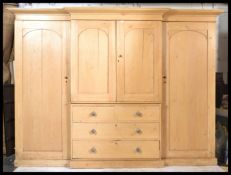 An exceptional Victorian 19th century breakfront triple wardrobe linen press compactum. This large