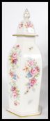 A Lynton porcelain vase of hexagonal form in the derby rose pattern. The vase of trumped form