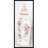 A Lynton porcelain vase of hexagonal form in the derby rose pattern. The vase of trumped form