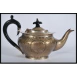 An early 20th century silver hallmarked Arts and Crafts movement teapot having a hand beaten