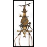 A seven day skeleton lantern style wall clock with single weight driven movement and pendulum,