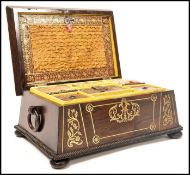 A Regency rosewood brass inlaid work box raised on