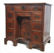 An 18th century Queen Anne walnut kneehole desk of