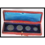 A set of  early 20th century 1902 Maundy coins. The four piece coin set in a fitted case. Largest