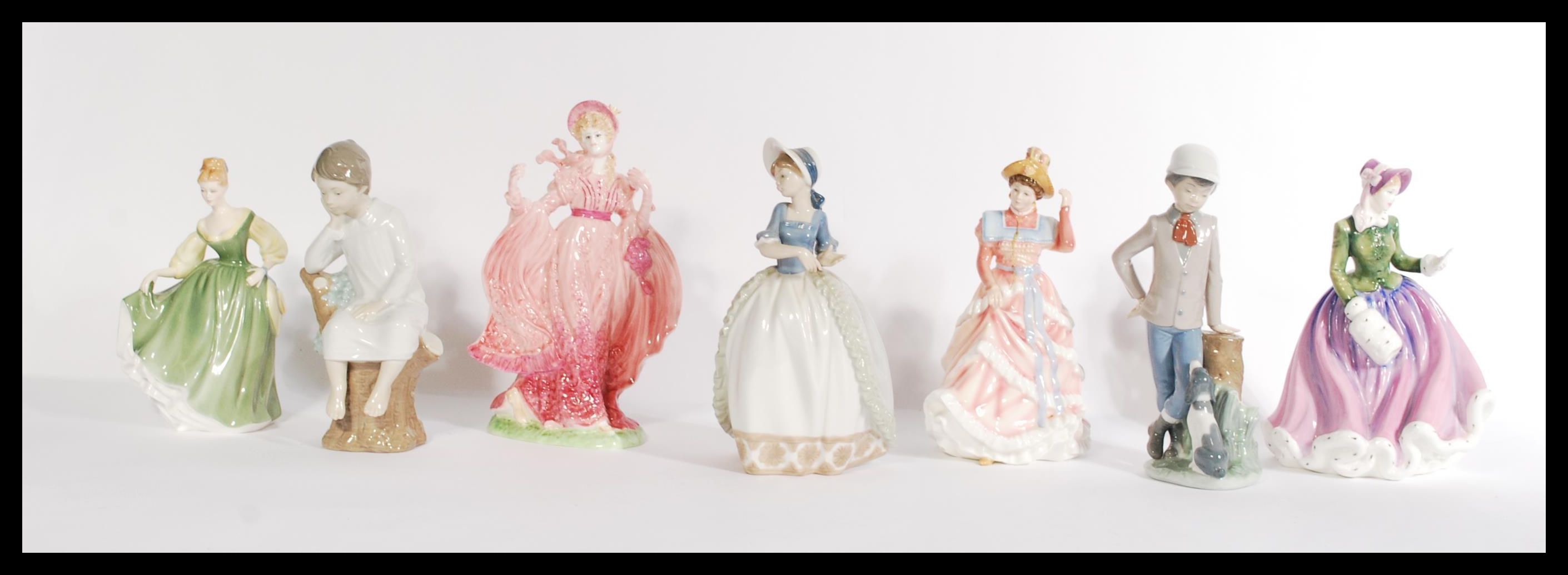 A group of seven Coalport Royal Doulton and Lladro Nao figurines to include two Nao boys and one Nao