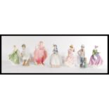 A group of seven Coalport Royal Doulton and Lladro Nao figurines to include two Nao boys and one Nao