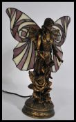A good quality 20th century table lamp in the form of a fairy with decorative wings in a Tiffany