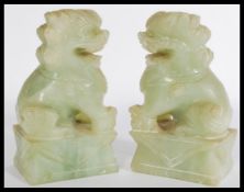 A pair of early 20th century jade or jadeite Fu do