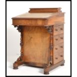 A 19th century VIctorian mahogany inlaid davenport desk. The hinged top with tooled leather