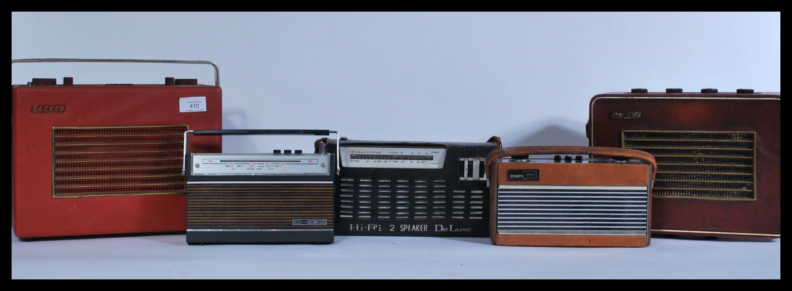 A group of vintage radios to include two Hacker Heralds , Roberts Rambler , ITT Tiny Super , De Luxe