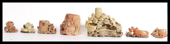 A group of early 20th century Chinese hand carved soapstone water brush pots including floral