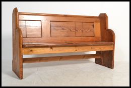 A Victorian 19th century small proportioned pitch pine pew of ecclesiastical form having a thick