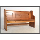 A Victorian 19th century small proportioned pitch pine pew of ecclesiastical form having a thick