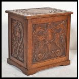 A 19th century Victorian oak box having carved geometric panels. The hinged lid opening to reveal